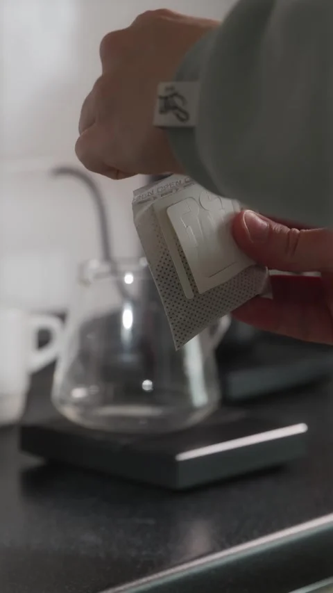 Opening fresh drip coffee filter bag vertical POV Stock Footage 338395194