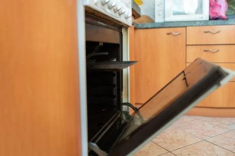 Opening the gas oven in kitchen while baking and cooking Stock Photos