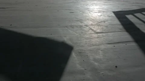 The opening of the gate, shadow on concrete floor. Stock Footage 136001101