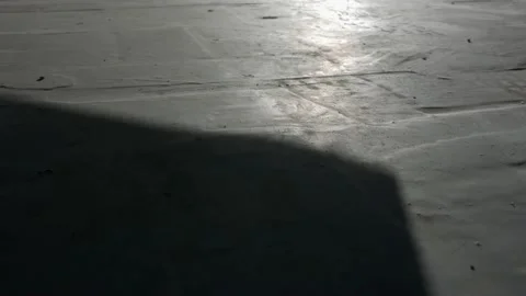 The opening of the gate, shadow on concrete floor. Stock Footage 136001988
