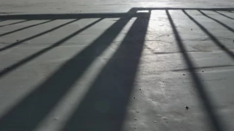 The opening of the gate, shadow on concrete floor. Stock Footage 136022539
