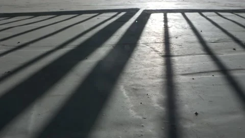 The opening of the gate, shadow on concrete floor. Stock Footage 136022547