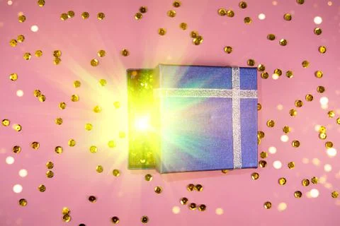 Opening a gift box with magical effects lights Stock Photos