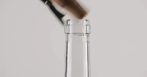Opening a glass bottle with a corkscrew in slow motion Stock Footage 342735376