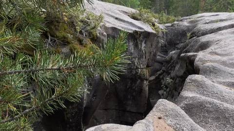 Opening to granite cave.  Cave opens like a giant fissure. Stock Footage 117583386