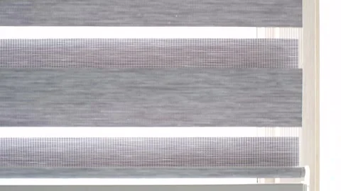 Opening gray striped blinds on a window close-up. Stock Footage 306332253