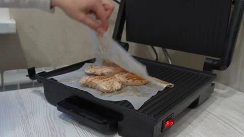 Opening grill on the table cooking meat on the kitchen Stock Footage 232944313