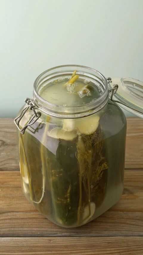 Opening a jar of pickled cucumbers, vertical view. Stock Footage 342144816