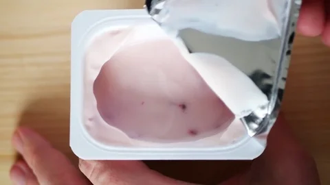 Opening a jar of yogurt. Stock Footage 70516371