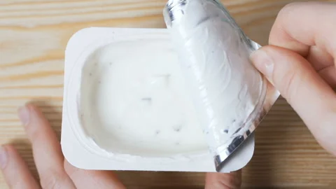 Opening a jar of yogurt. Stock Footage 103985315