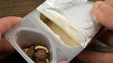 Opening a jar of yogurt. Stock Footage 113335399