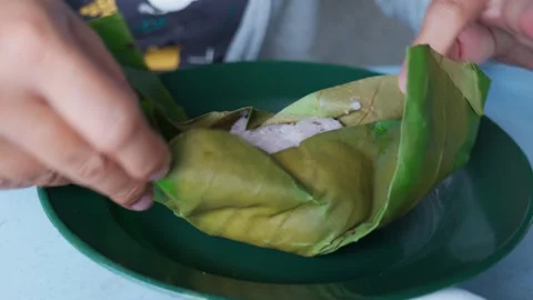 Opening a leave wrap rice Stock Footage 300849131