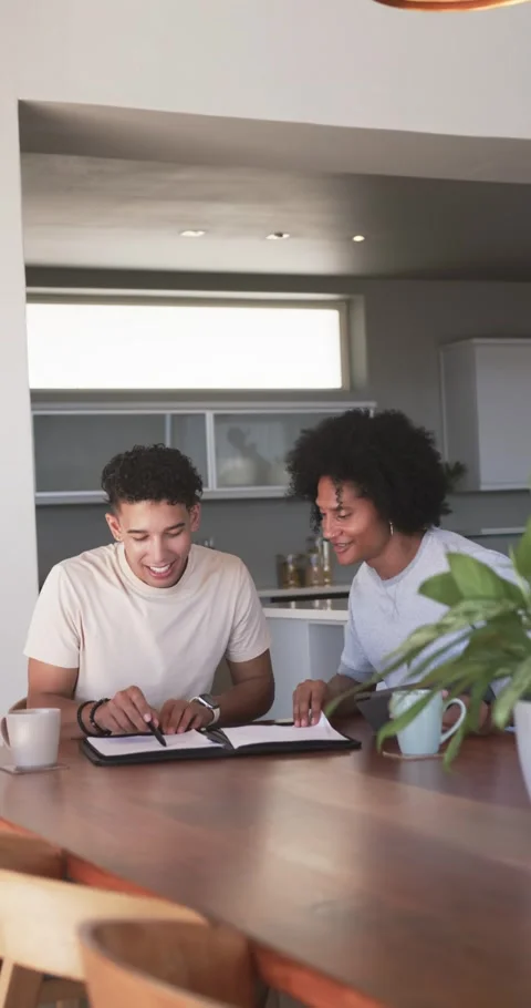 Opening left man flipping binder, two men checking and signing documents with Stock Footage 345492844
