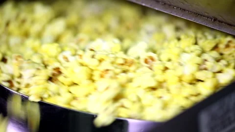 Opening lid of automatic rotating popcorn making machine full caramel cheese swe Stock Footage 137541618