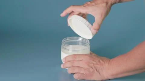 Opening the lid of a fermented yogurt container Stock-Footage 345881737
