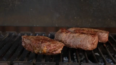 Opening the lid of grill to check steaks on grid 스톡 동영상 250444202