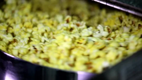 Opening lid of rotating automatic popcorn making machine full caramel sweet chee Stock Footage 137541631