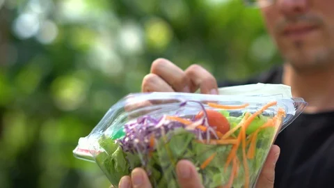 Opening Lid of Take Away Salad in Plastic Container in Park Stock Footage 102257630