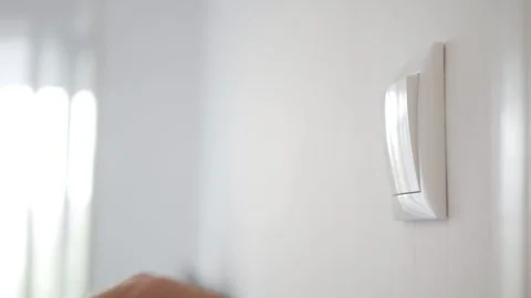 Opening the Light from the Switch in the Office. One Person Turning on the Light Stock Footage 312118853