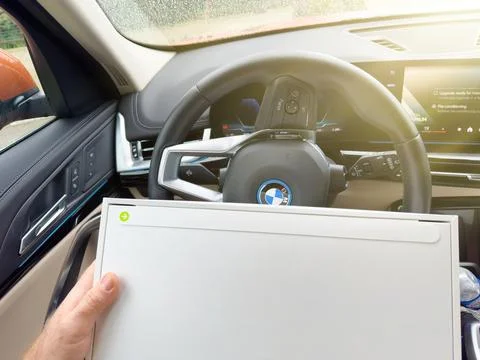 Opening MacBook Pro Inside Electric BMW Stock Photos