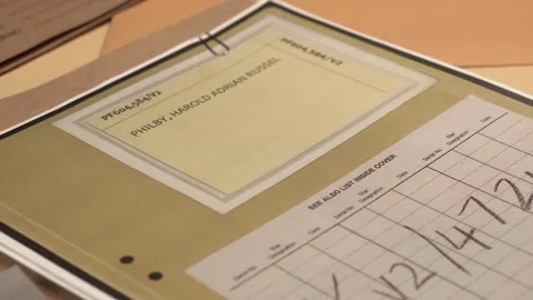 Opening MI6 File Folder With Photo and Declassified Documents About Kim Philby Stock Footage 328469343