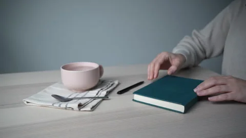 Opening notebook on minimal desk with coffee Video stock 328004023