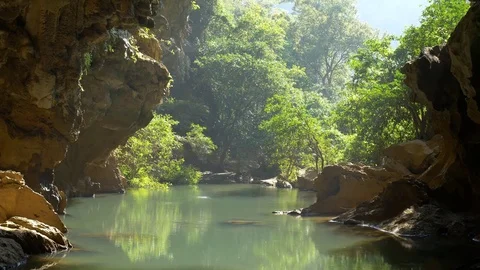 The opening or mouth of an underground river cave Stock Footage 71771057