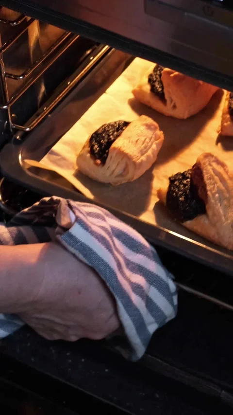 Opening the oven and checking the bottom side of freshly baked Leaf Fat Pastry Stock Footage 270554360