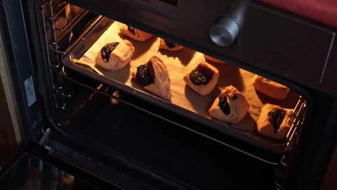 Opening the oven and checking the bottom side of freshly baked Leaf Fat Pastry Stock Footage 270555436
