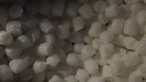 Opening a Package- Hand reaches into Packaging Peanuts Stock Footage 135332419