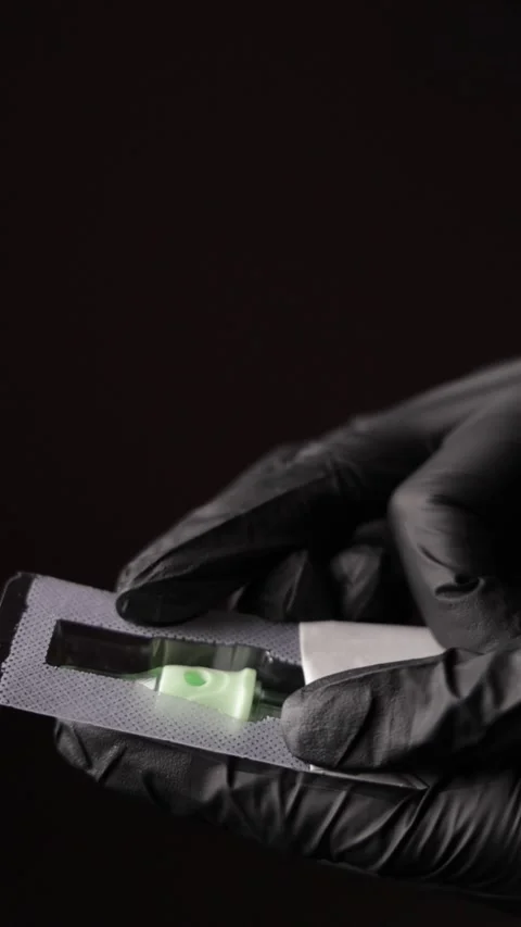Opening a Packet with a Tattoo Needle Stock Footage 300480945