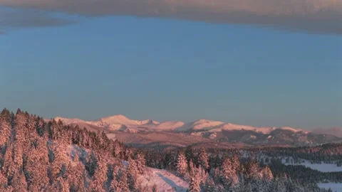 Opening pan down sunrise Rocky Mountains majesty Mount Blue Sky Evergreen Stock Footage 336274382
