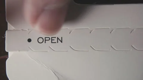 Opening a paper packaging box by tearing a strip off Stock Footage 314775760