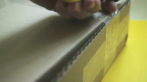 The opening of the parcel with a box cutter. Large cardboard box. Close up Stock Footage 86004755
