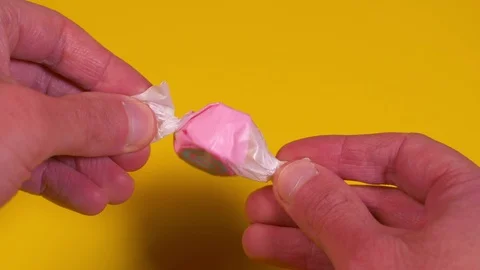 Opening a Piece of Taffy Candy Stock-Footage 98244978