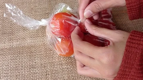 Opening a plastick of fresh tomatoes Stock Footage 149957326