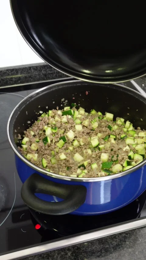 Opening a pot with minced beef and vegetables Stock Footage 296488215