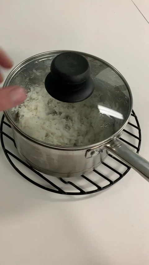 Opening a pot of white rice Stock Footage 162848391