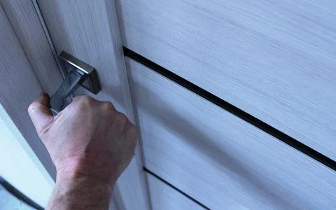 Opening with a push of the light door with a man's hand Stock Photos