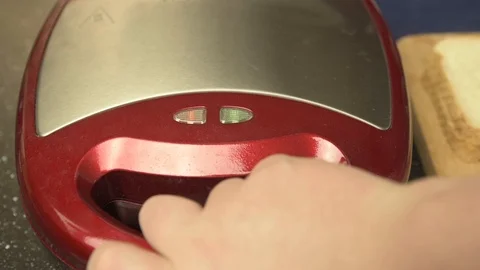 Opening red grill and put inside sandwich with cheese. Stock Footage 119646754