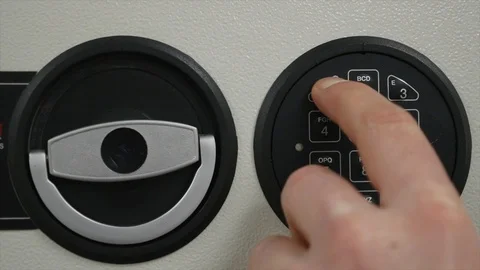 Opening the safe with a combination of numbers by hand and entering the code Stock Footage 86529588