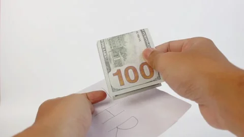 Opening a salary envelope containing dollar bills isolated on a white background Stock Footage 328427633