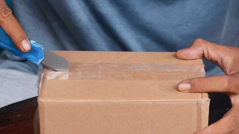 Opening a sealed cardboard box Stock Footage 340621102