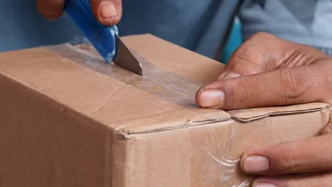 Opening a sealed cardboard box Stock Footage 340621106