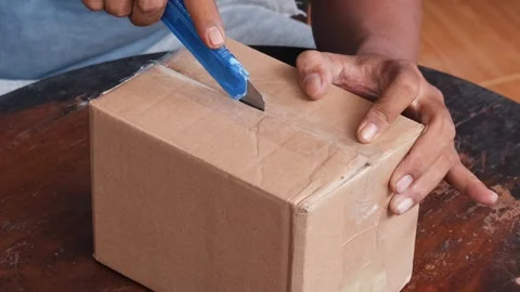 Opening a sealed cardboard box Stock Footage 340621108