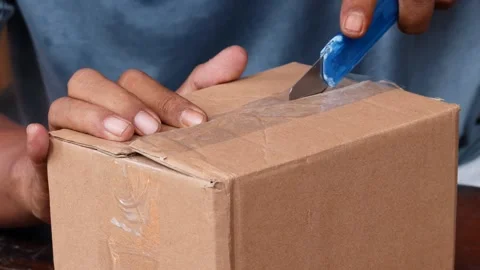 Opening a sealed cardboard box Stock Footage 340621110