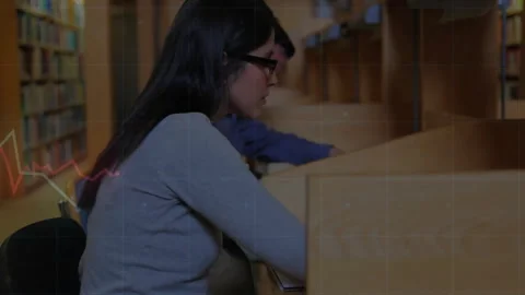 Opening shot showing classmates sitting carrels writing notes animated graphs Video stock 312280166