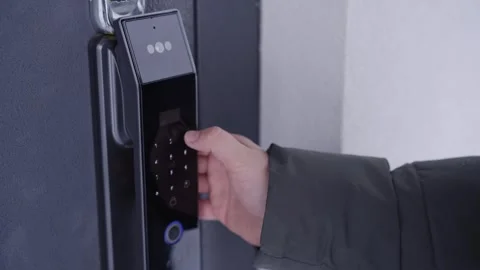 Opening a Smart Door Lock by Entering a Code Stock Footage 328645446