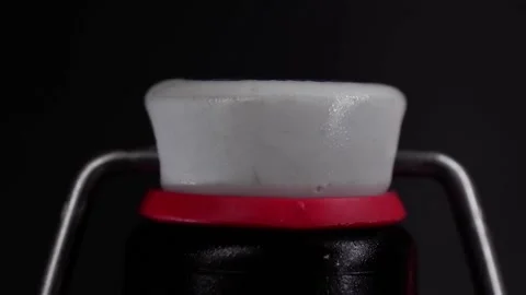 Opening a swing top bottle in slow motion Stock Footage 169820477
