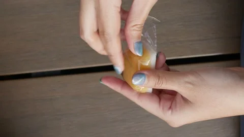 Opening talam ubi kuning from plastic. Indonesian traditional food, cake, s.. Stock-Footage 294276987